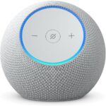 Spherical smart speaker with gray fabric exterior and a circular control panel displaying minus, mute, and plus symbols, surrounded by a blue LED ring.