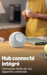 Spherical smart speaker on a wooden table with a blurred person holding a mug in the background; ad banner for a connected hub.