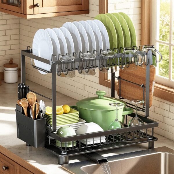 Dish drying rack with white and green plates, mugs, and glassware drying over a kitchen sink area.