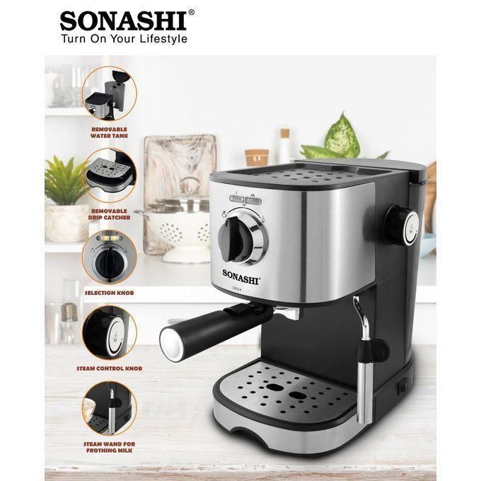 Stainless steel Sonashi espresso machine on a kitchen counter with labeled features: removable water tank, removable drip catcher, selection knob, steam control knob, and steam wand for frothing milk.