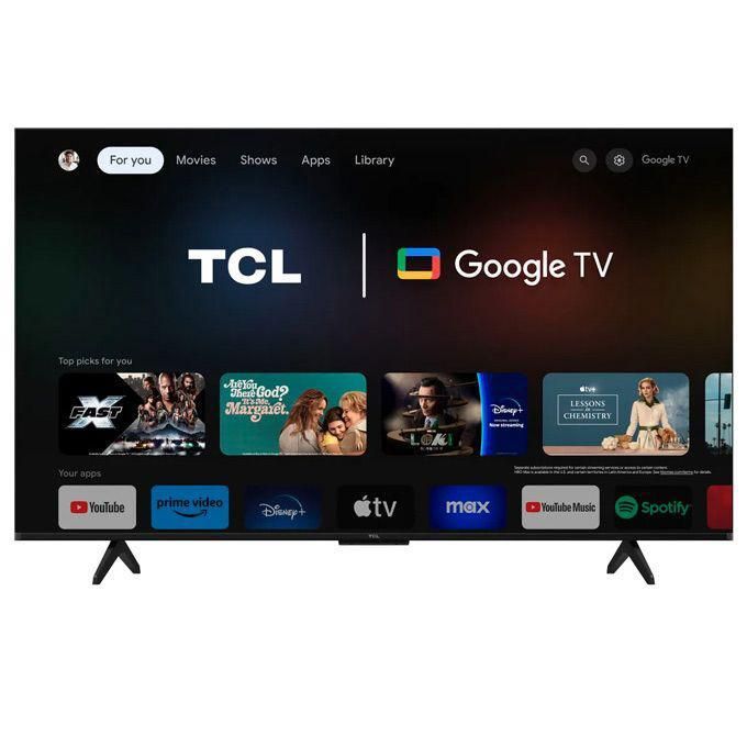TCL TV displaying Google TV home screen with app row and logos on a dark background inside a living room setup