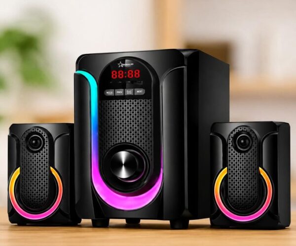 Black multimedia speaker system with a central subwoofer and two satellite speakers, each with colorful RGB ring lighting on a wooden table.