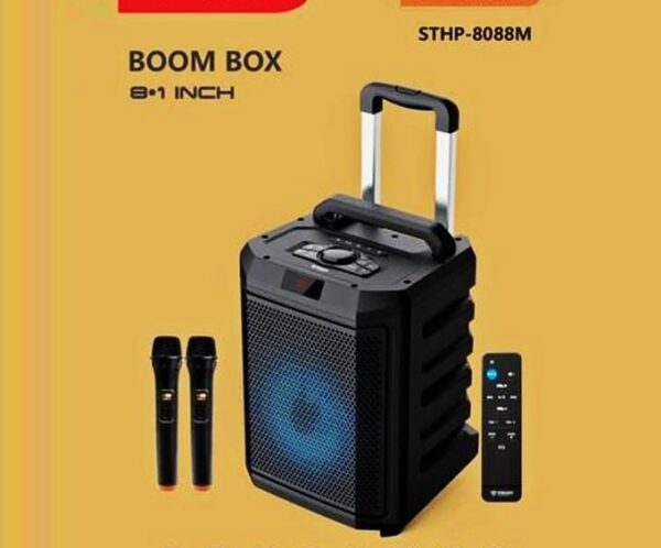 Portable Bluetooth boom box with a blue-lit front speaker, carrying handle, two wireless mics, and a tall remote on a yellow background (SHTP-8088M).