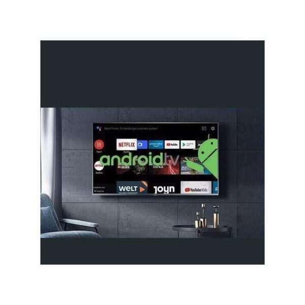 Flat-screen TV on a dark paneled wall displaying Android TV home screen with app icons and a green Android mascot overlay on the right.
