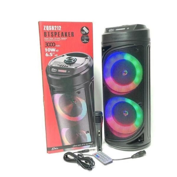 Portable Bluetooth speaker with rainbow LED ring lights, shown beside its box, remote, and power cable.