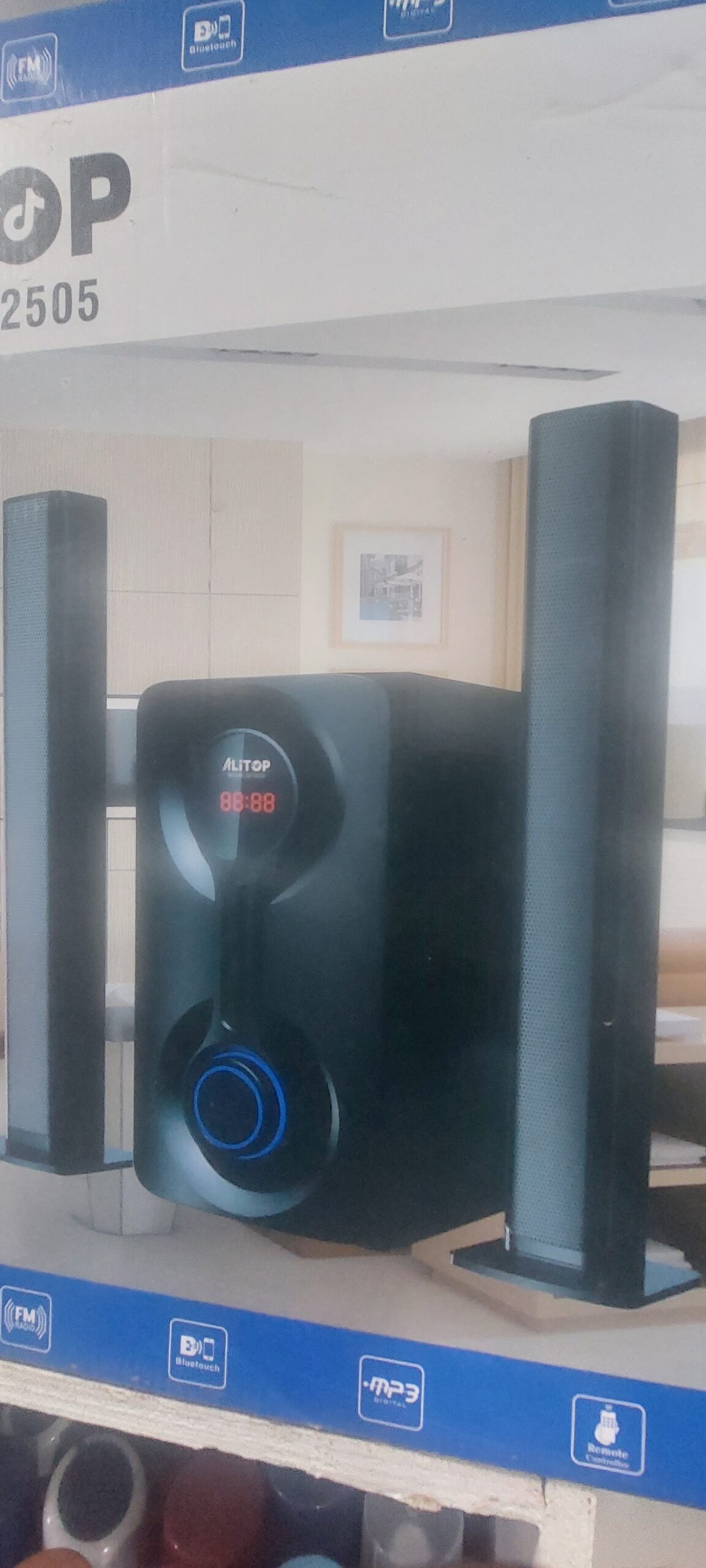 Home theater speaker system with two tall satellite speakers and a central unit showing a digital display reading 88:88 (brand 'ALTOP').