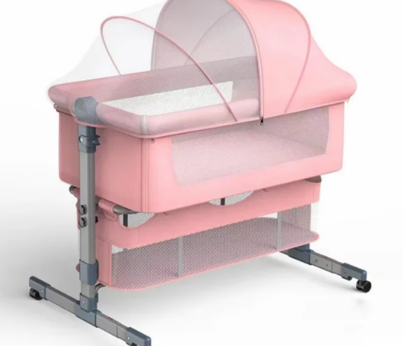 Pink baby bassinet on a metal rolling stand with mesh sides and a soft curved canopy, designed for infant sleep.