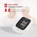 Elderly couple smiling with a digital blood pressure monitor in the foreground; text promotes a two-user switch to store readings and monitor health.