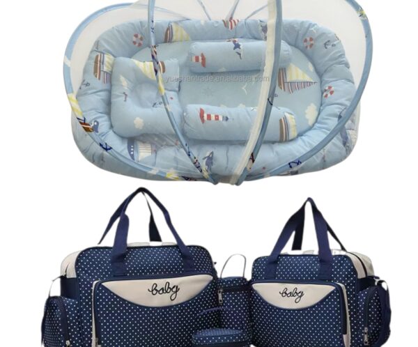 Navy blue polka-dot diaper bag set with multiple compartments and matching changing pad and accessories.