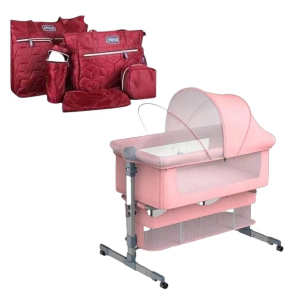 Pink baby playpen with mesh sides and canopy, shown with red quilted travel bags in the background.