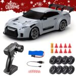 Remote-controlled toy race car with spoiler and racing decals, plus accessories like battery pack and charger fall out around it.