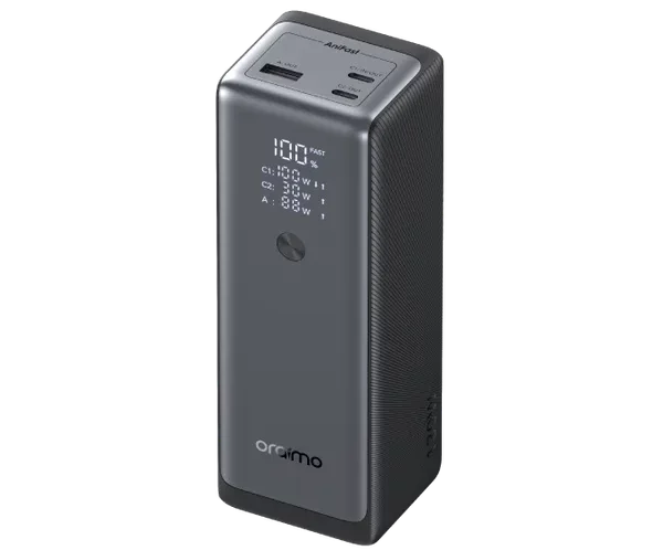Dark gray portable power station standing upright with a digital display showing 100% and USB ports on top (Orimo brand).