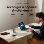Wall text explains charging 3 devices at once; a USB-C hub on a desk powers a laptop, tablet, and phone as a man writes on the laptop.