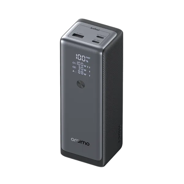 Dark gray portable power station standing upright with a digital display showing 100% and USB ports on top (Orimo brand).