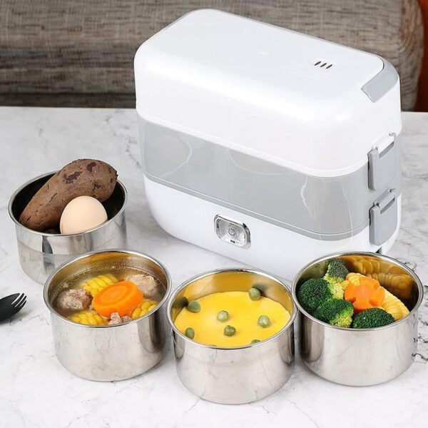 White electric lunch box on a marble counter surrounded by five stainless steel food containers with mixed meals like corn, broccoli, and vegetables.
