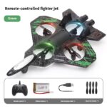 Green remote-controlled fighter jet with four propellers; accessories shown: remote control, lithium battery, USB charging cable, and four spare fan blades.