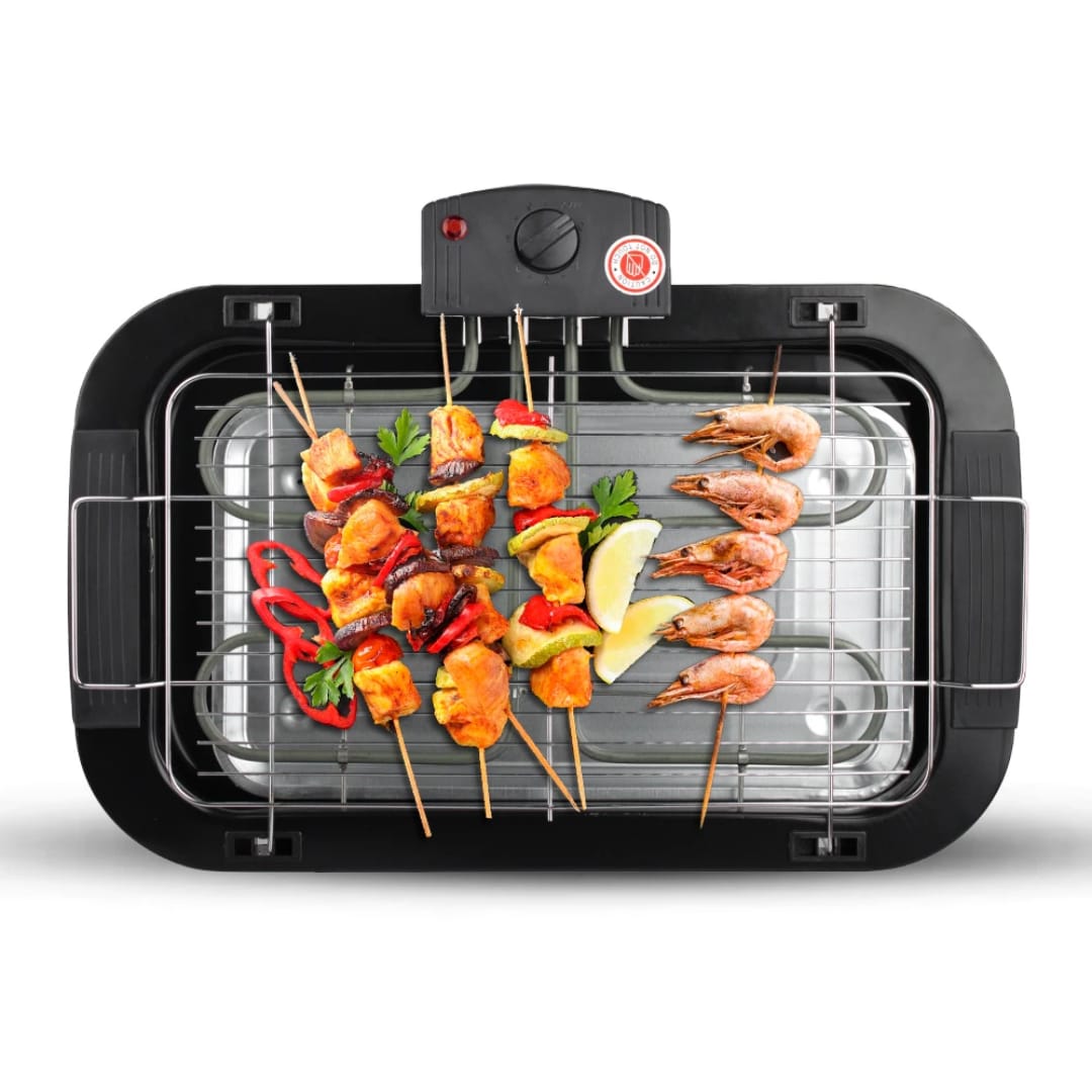 Electric grill with skewers of chicken, shrimp, peppers, parsley, and lemon wedges on the rack