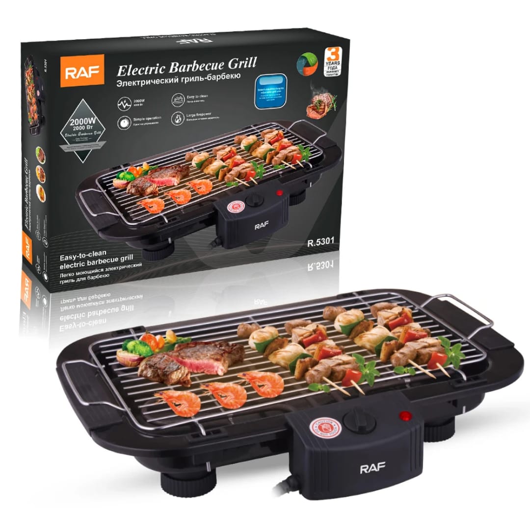 Electric barbecue grill with skewers cooking on a black grill, shown with its box in the background for reference and branding RAF.